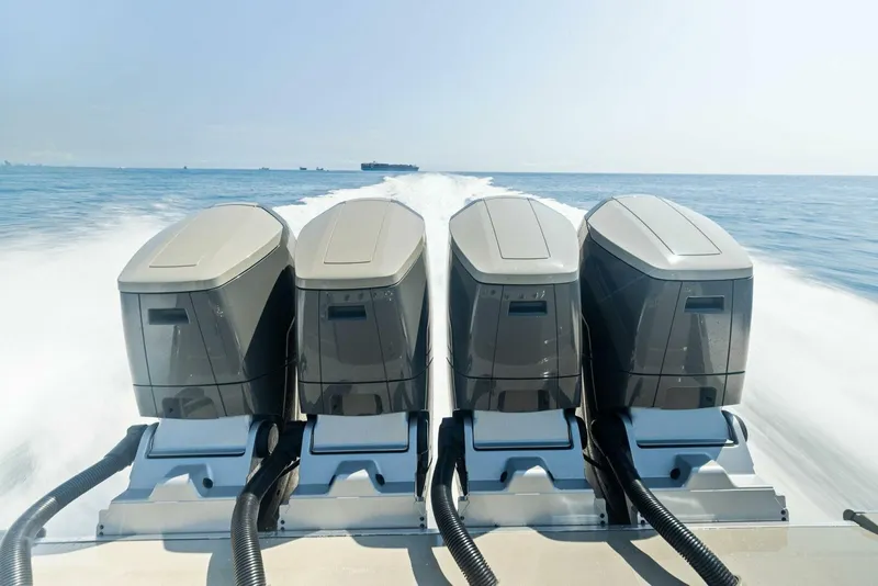 Slide: The Image of 2023 HCB 53 Sueños boat with four powerful outboard engines on open water. - 24