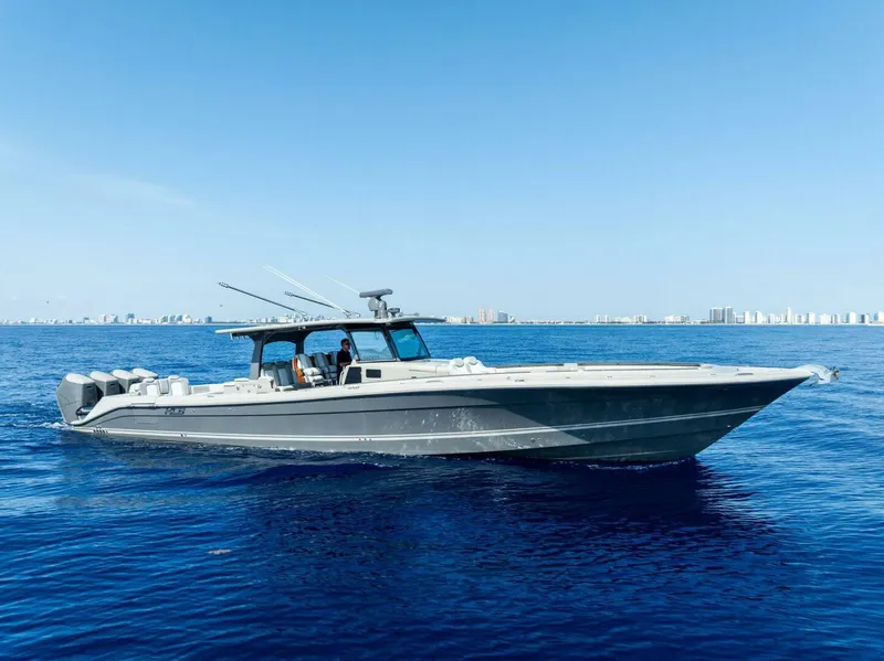 Slide: The Image of 2023 HCB 53 Sueños boat cruising on open blue water under clear sky. - 41