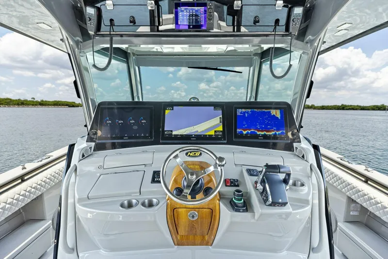 Slide: The Image of 2023 HCB 53 Sueños boat dashboard with advanced navigation screens and controls. - 9