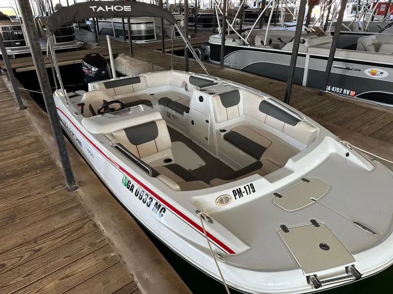 Slide: The Image of 2021 Tahoe 1950 boat docked, featuring spacious seating and sleek design. - 1