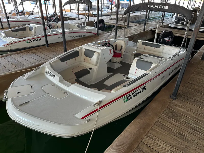 Slide: The Image of Open storage compartment on a 2021 Tahoe 1950 boat, featuring a white interior. - 16