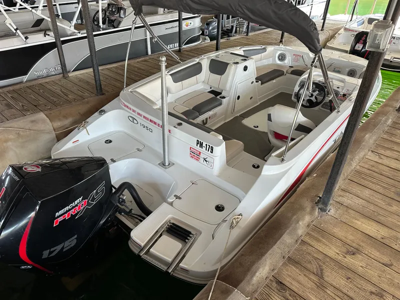 Slide: The Image of 2021 Tahoe 1950 boat with Mercury Pro XS 175 engine docked at marina. - 2