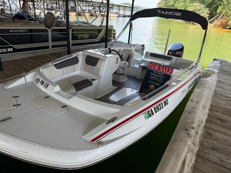 Slide: The Image of Open storage compartment on a 2021 Tahoe 1950 boat with gray carpet flooring. - 21