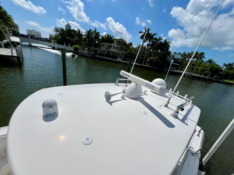 Slide: The Image of 2015 Intrepid 375 Center Console boat docked by a scenic waterfront. - 10