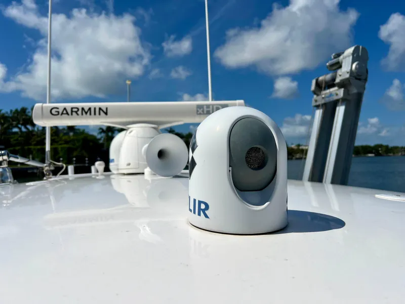 Slide: The Image of 2015 Intrepid 375 Center Console with Garmin and FLIR equipment under a clear blue sky. - 11