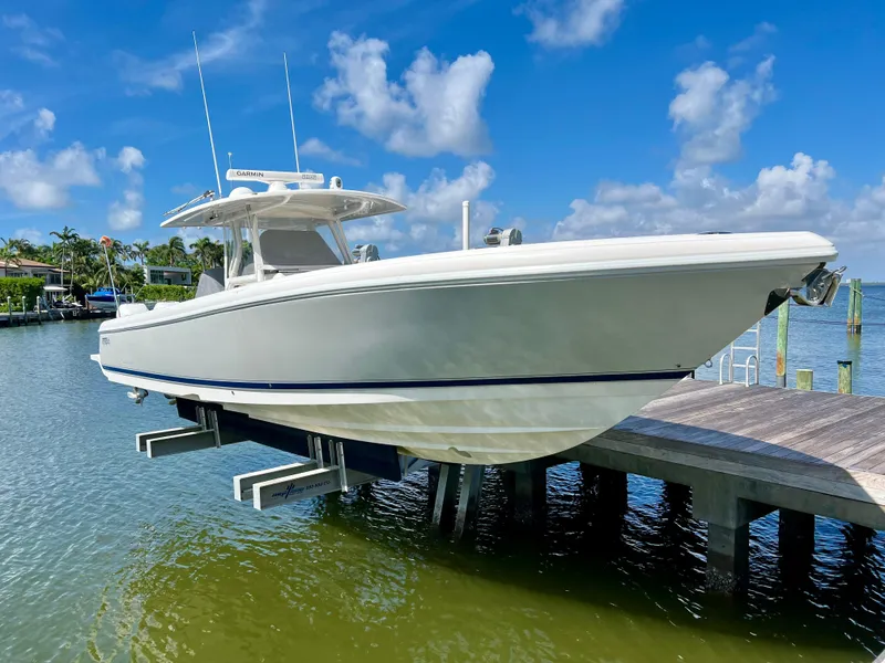 Slide: The Image of 2015 Intrepid 375 Center Console boat with triple engines on a calm waterway. - 4