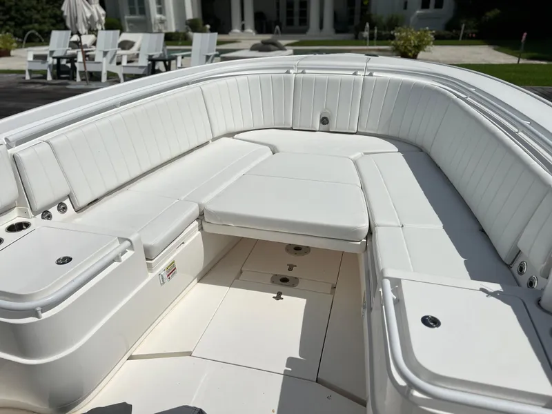 Slide: The Image of 2015 Intrepid 375 Center Console boat on calm water, surrounded by lush greenery. - 5