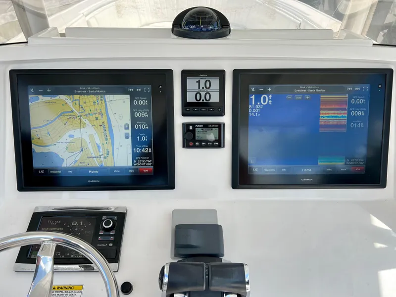 Slide: The Image of Control panel of a 2015 Intrepid 375 Center Console with navigation displays. - 8