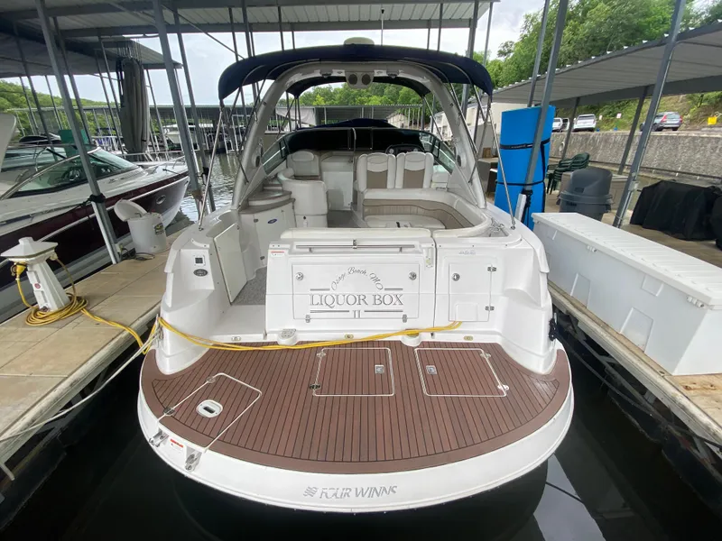 Slide: The Image of 2005 Four Winns 348 Vista yacht docked, rear view with spacious deck and seating. - 26