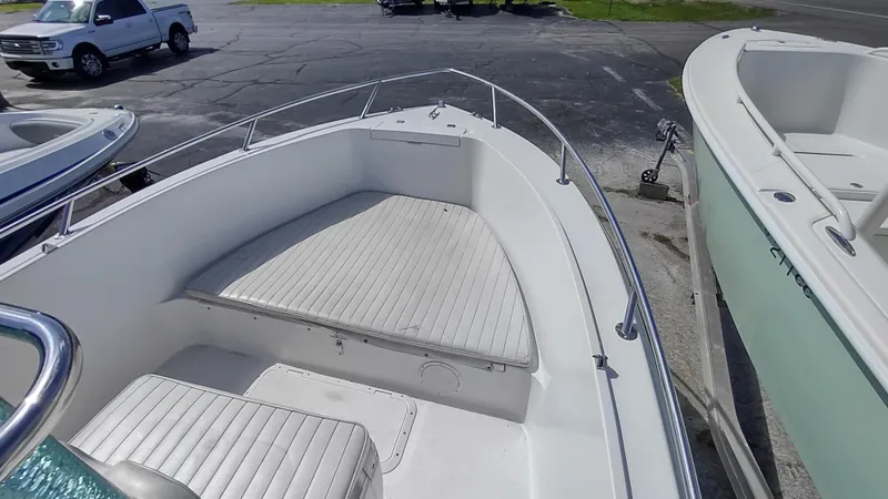 Slide: The Image of Robalo 2020 Center Console boat, 2001 model, docked with visible seating and railing. - 7
