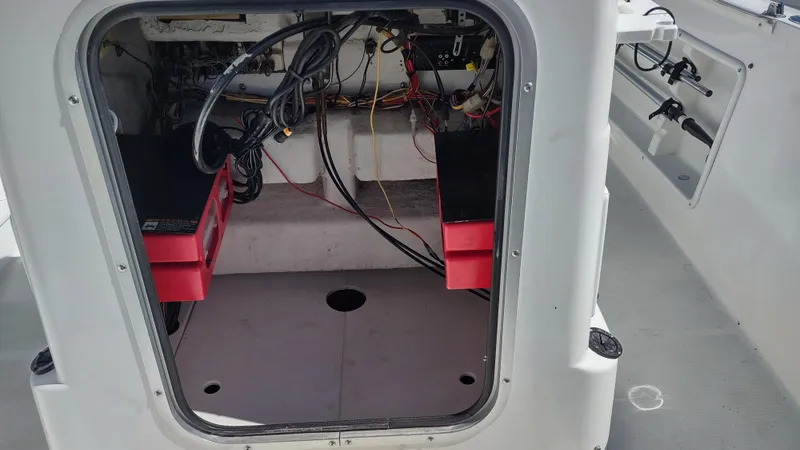 Slide: The Image of Open compartment of 2001 Robalo Center Console boat showing wiring and storage. - 9