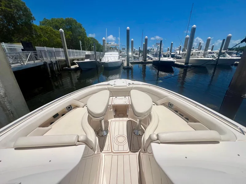 Slide: The Image of 2021 Grady-White Freedom 375 boat docked at marina, clear sky, calm water. - 18