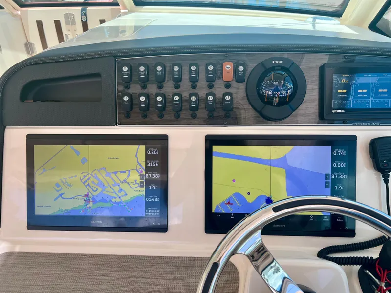 Slide: The Image of Dashboard of 2021 Grady-White Freedom 375 with navigation screens and controls. - 20