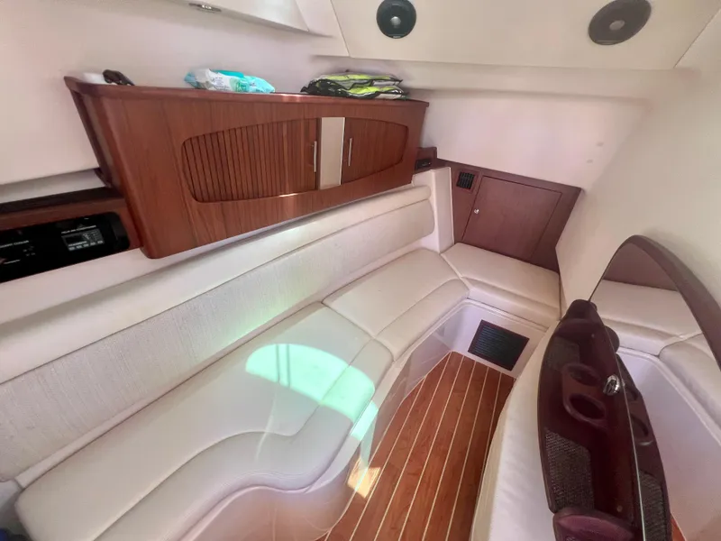Slide: The Image of 2021 Grady-White Freedom 375 cabin interior with wood accents and white seating. - 23