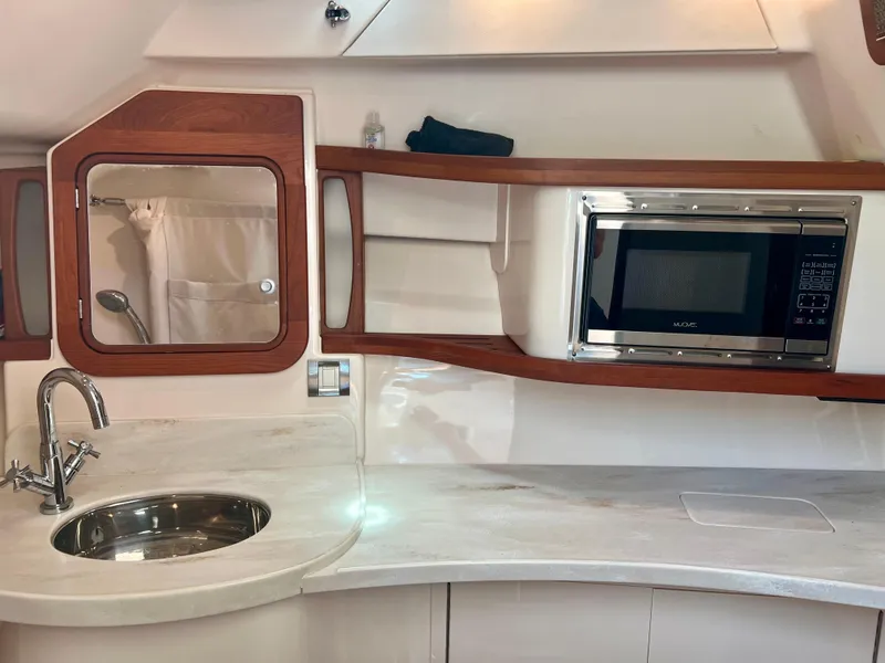 Slide: The Image of Interior of 2021 Grady-White Freedom 375 boat with sink and microwave. - 27