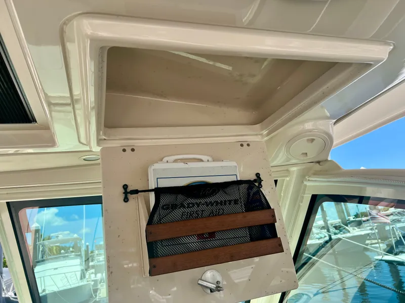 Slide: The Image of 2021 Grady-White Freedom 375 boat interior storage compartment with mesh organizer. - 30