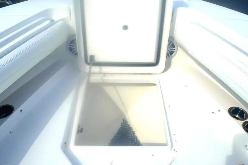 Slide: The Image of 2021 Regulator 25 boat storage compartment with open hatch, showcasing interior space. - 15