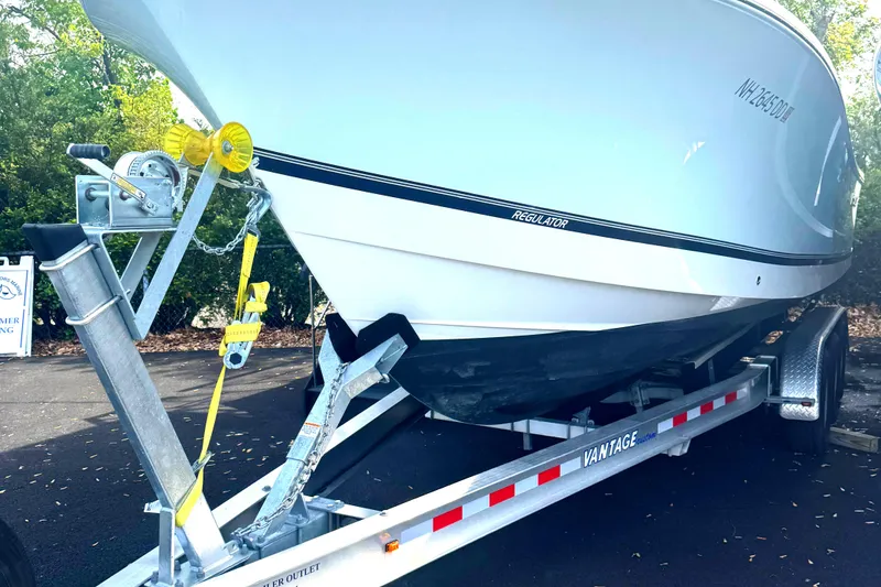 Slide: The Image of 2021 Regulator 25 boat on Vantage trailer, parked outdoors. - 5