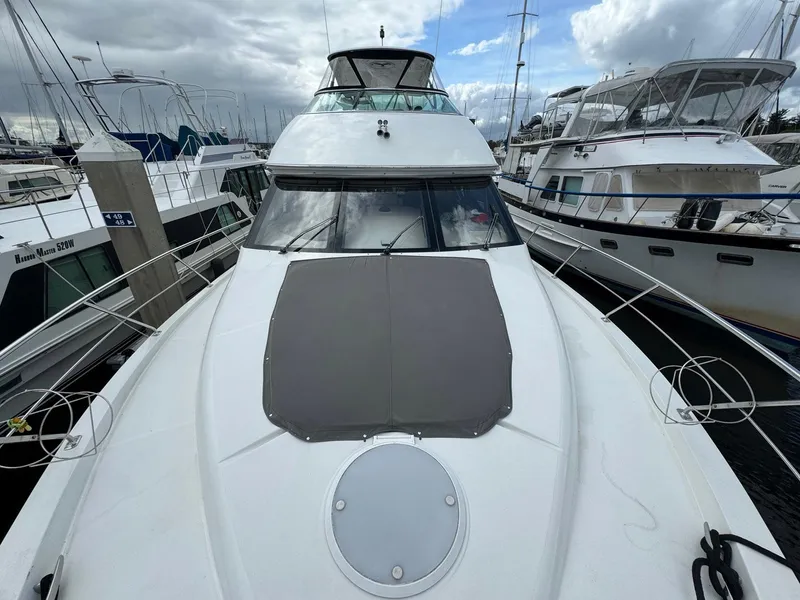 Slide: The Image of 2006 Carver 56 Voyager yacht docked at marina under cloudy sky. - 10