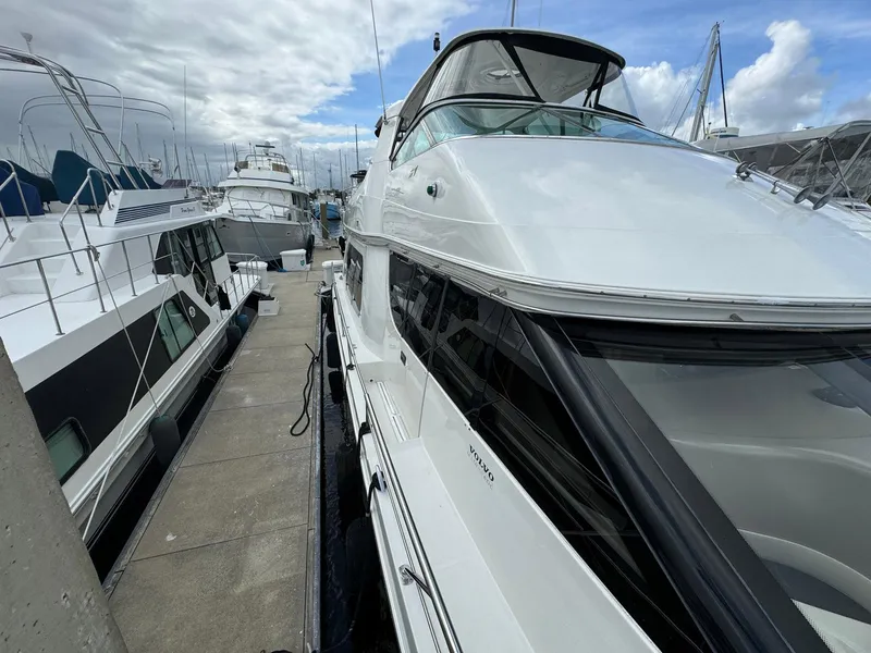 Slide: The Image of 2006 Carver 56 Voyager yacht docked at marina under cloudy sky. - 11