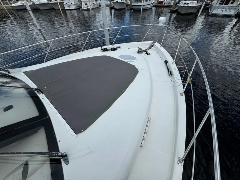 Slide: The Image of 2006 Carver 56 Voyager yacht deck with railing, docked at marina. - 12
