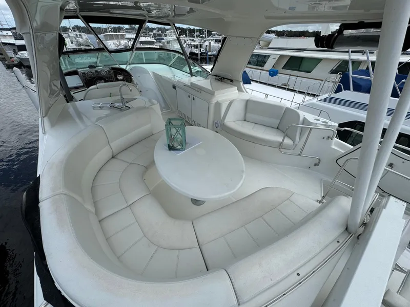Slide: The Image of Luxurious 2006 Carver 56 Voyager yacht with spacious white seating area. - 14