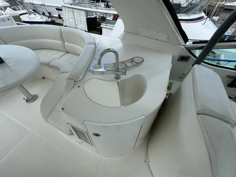 Slide: The Image of 2006 Carver 56 Voyager yacht interior with sink and seating area. - 16