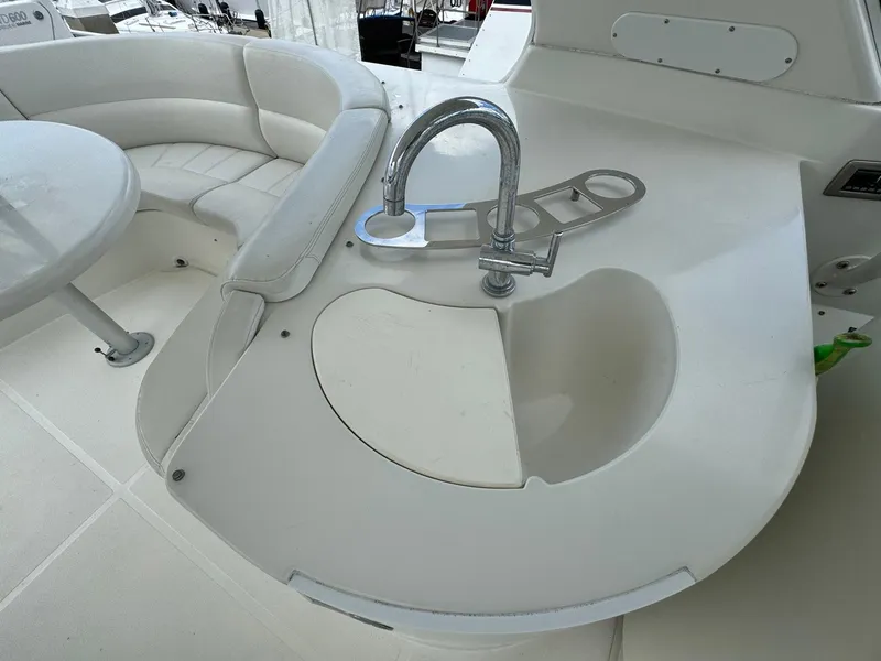 Slide: The Image of 2006 Carver 56 Voyager yacht interior with sink and seating area. - 17