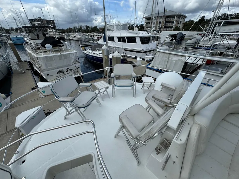 Slide: The Image of 2006 Carver 56 Voyager yacht with seating area, docked at a marina. - 21