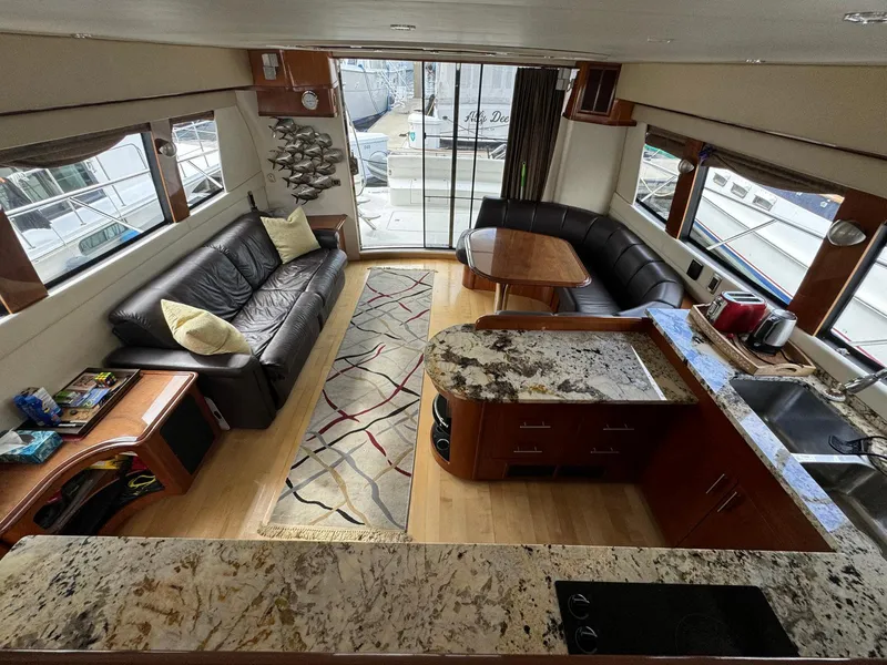 Slide: The Image of Luxurious interior of 2006 Carver 56 Voyager yacht with modern kitchen and seating area. - 26