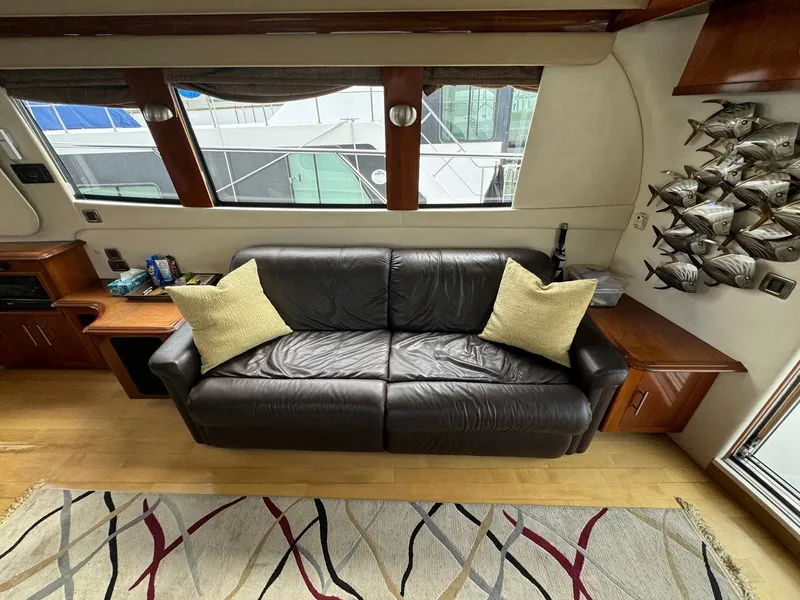 Slide: The Image of Luxurious interior of 2006 Carver 56 Voyager yacht with leather sofa and decorative pillows. - 29