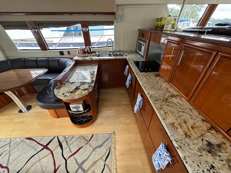 Slide: The Image of Luxurious 2006 Carver 56 Voyager yacht interior with elegant kitchen and seating area. - 31