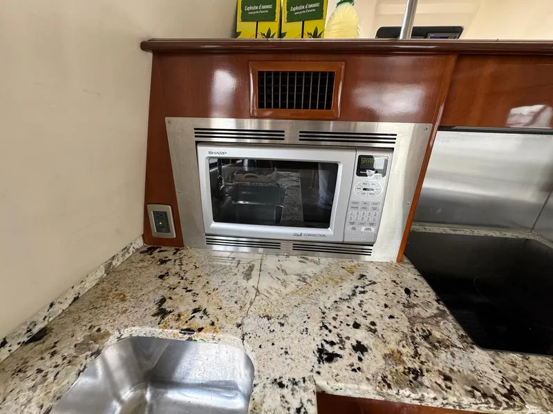 Slide: The Image of 2006 Carver 56 Voyager kitchen with granite countertop, built-in microwave, and stainless steel sink. - 33