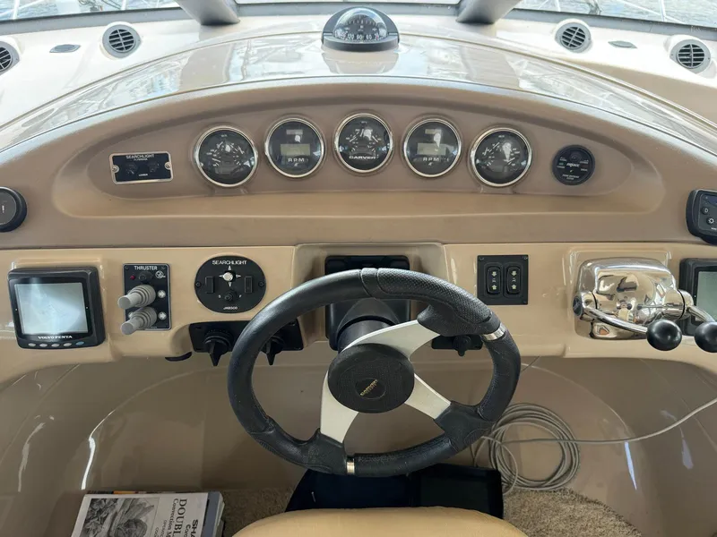Slide: The Image of 2006 Carver 56 Voyager helm with steering wheel, gauges, and navigation controls. - 38