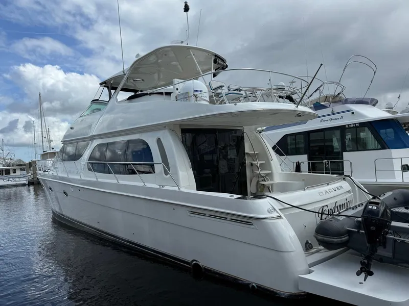 Slide: The Image of 2006 Carver 56 Voyager yacht docked at marina under cloudy sky. - 4