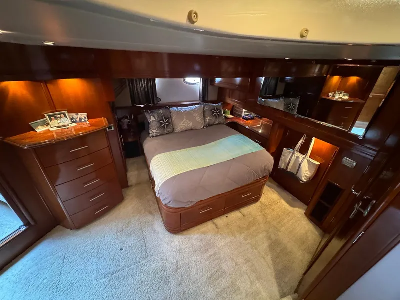 Slide: The Image of Luxurious 2006 Carver 56 Voyager bedroom with elegant wood finishes and cozy bedding. - 42