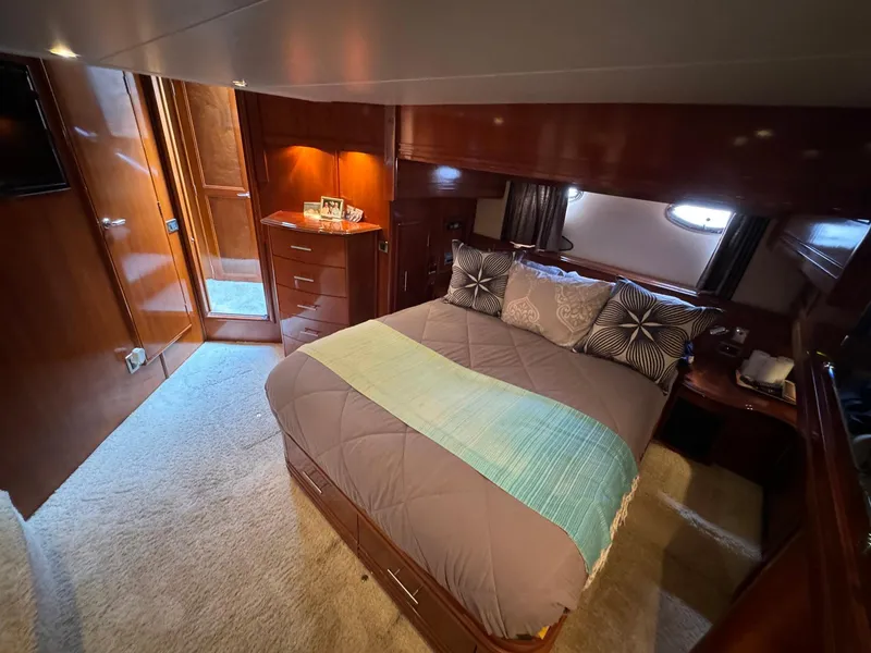 Slide: The Image of Luxurious bedroom interior of 2006 Carver 56 Voyager yacht with elegant wood finishes. - 43