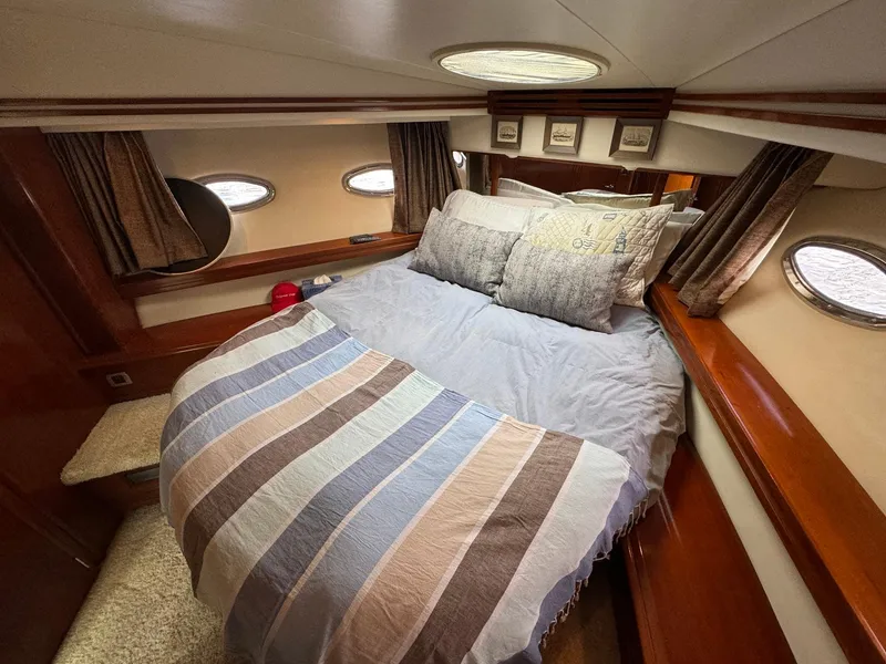 Slide: The Image of Luxurious bedroom interior of 2006 Carver 56 Voyager yacht with cozy bedding. - 49