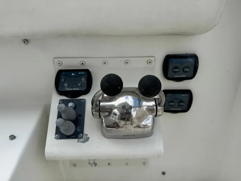 Slide: The Image of Control panel of a 2006 Carver 56 Voyager yacht with throttle and switches. - 8