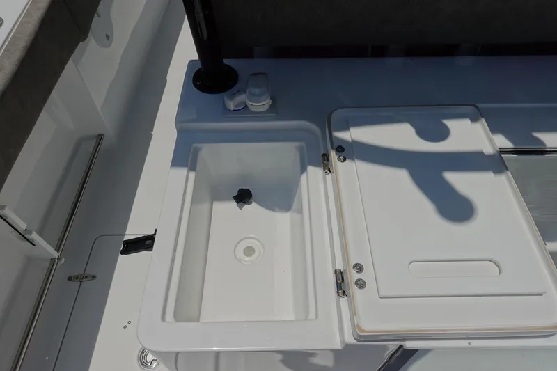 Slide: The Image of 2026 Sea Hunt Gamefish 30 Forward Seating boat interior with storage compartment. - 17