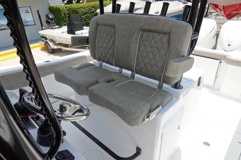 Slide: The Image of 2026 Sea Hunt Gamefish 30 boat with plush forward seating and modern steering console. - 21