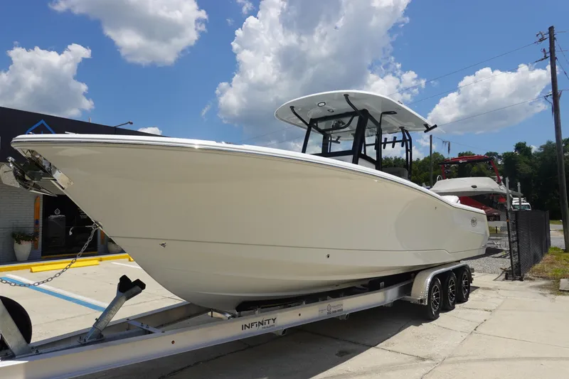 Slide: The Image of 2026 Sea Hunt Gamefish 30 boat on trailer under a cloudy sky. - 3