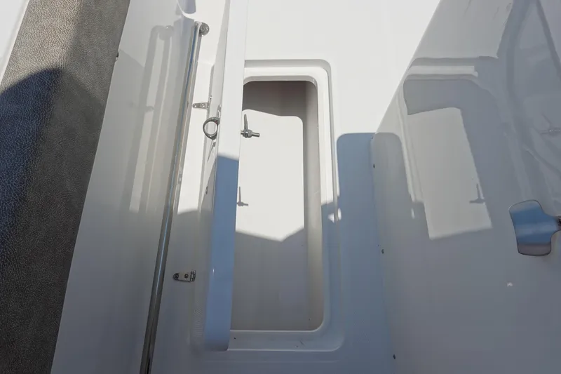 Slide: The Image of 2026 Sea Hunt Gamefish 30 Forward Seating storage compartment, open and empty. - 45