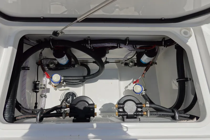 Slide: The Image of 2026 Sea Hunt Gamefish 30 Forward Seating boat compartment with pumps and wiring. - 49