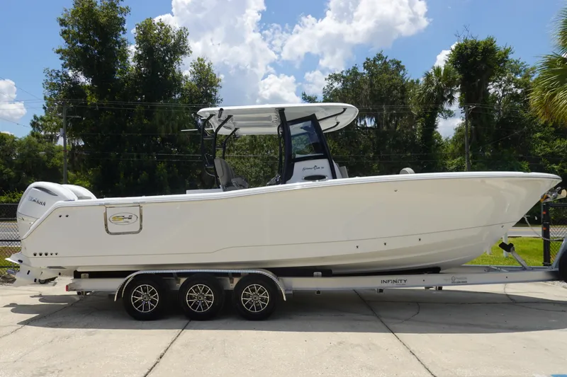 Slide: The Image of 2026 Sea Hunt Gamefish 30 Forward Seating boat on trailer, parked outdoors. - 6