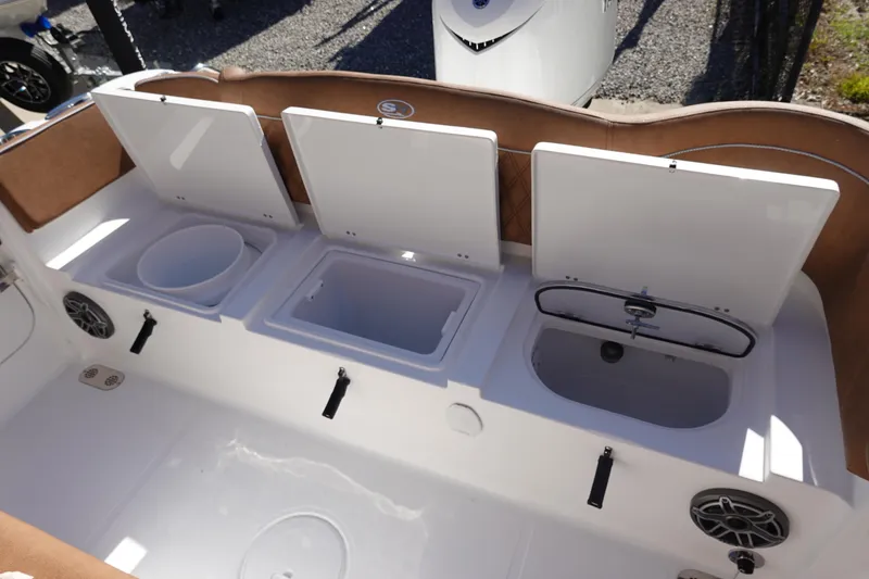 Slide: The Image of 2026 Sea Hunt Ultra 255 SE boat interior with open storage compartments and speakers. - 11