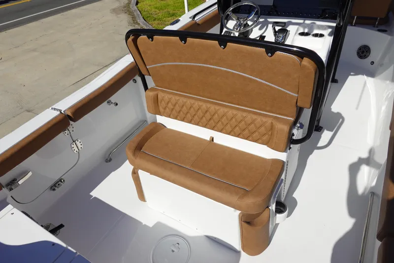 Slide: The Image of 2026 Sea Hunt Ultra 255 SE boat interior with brown cushioned seating. - 12