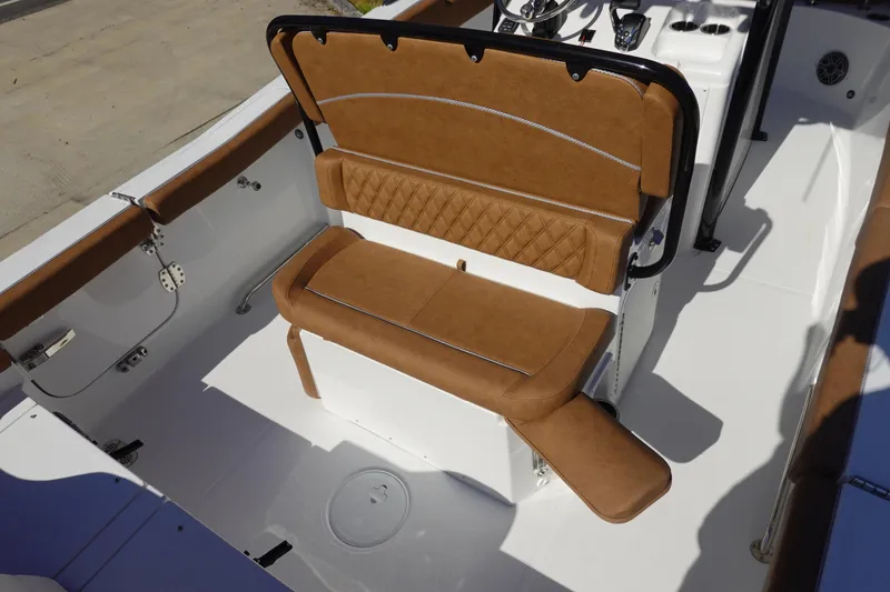 Slide: The Image of 2026 Sea Hunt Ultra 255 SE boat interior with brown cushioned seating. - 14