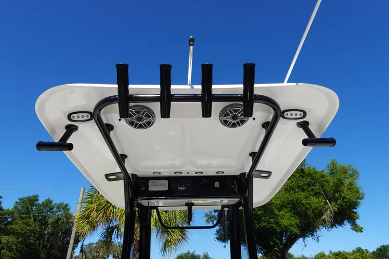 Slide: The Image of 2026 Sea Hunt Ultra 255 SE boat top view with rod holders and speakers against blue sky. - 15