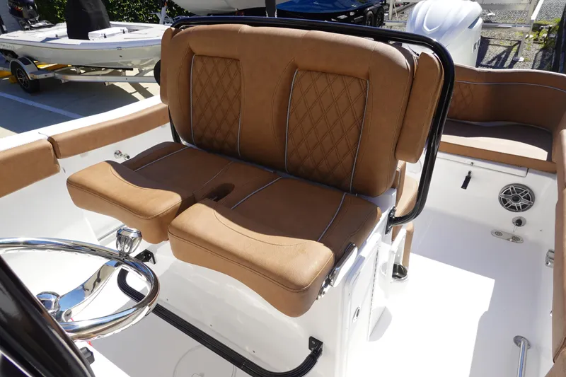 Slide: The Image of 2026 Sea Hunt Ultra 255 SE boat with tan leather seating and steering wheel. - 17